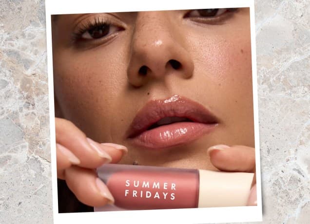 Model holding summer fridays lip oil on sale for black friday teen beauty