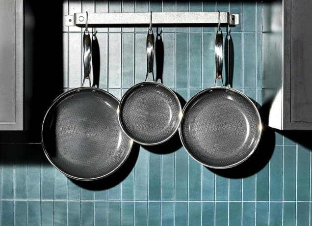 hexclad black friday sale: hexclad pans hanging above a stove