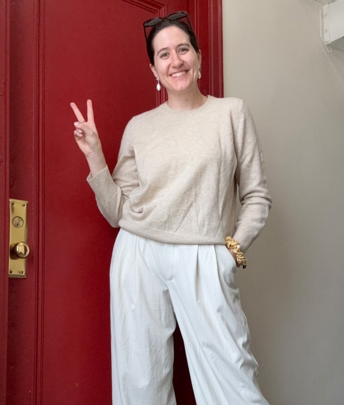 best-cashmere-sweaters: Naadam cashmere sweater on woman flashing peace sign