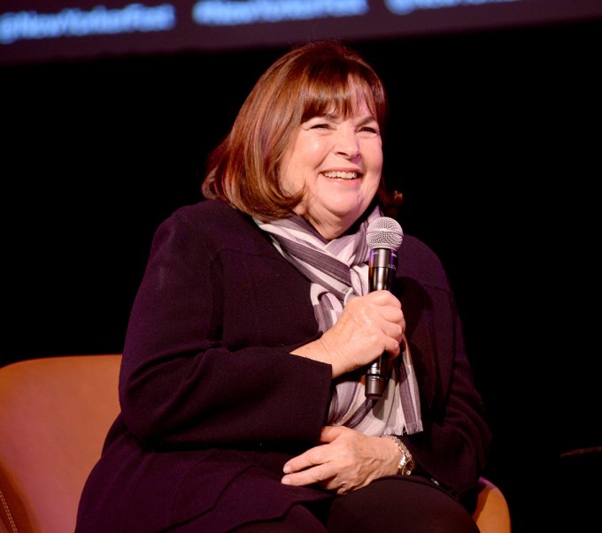 ina garten corn cutting hack: ina garten holding a microphone and smiling