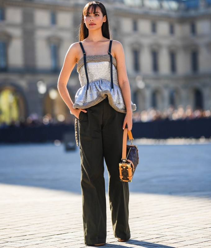 woman wearing a silver peplum top
